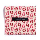 Folded fabric sandwich bag with pink and red apple print