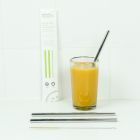 Plastic free straws being used in a glass of orange juice, suitable for kids