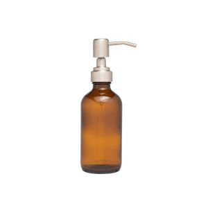 a small amber glass refillable cleaning bottle with a silver metal pump action top