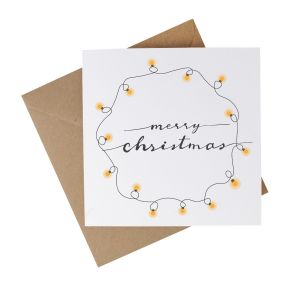 a recycled paper christmas card with text reading Merry Christmas, surrounded by festive lights